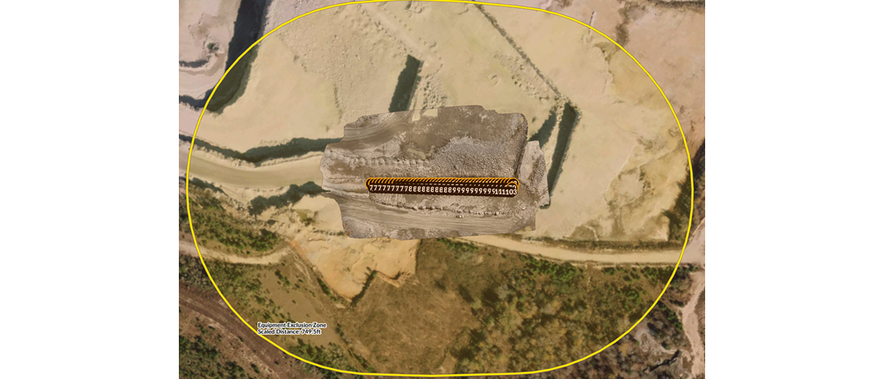 Aerial view of a quarry with a detailed 3D model of a rock face overlaid in the center. A segmented orange area with the numerical sequence "7777777778888888899999999911103" is visible on the rock face. A large yellow circle encompasses the entire scene, labeled in the bottom left as "Equipment Exclusion Zone" with a "Scaled Distance: 749.5 ft".